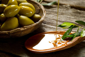 Olives and Olive Oil Over Spoon